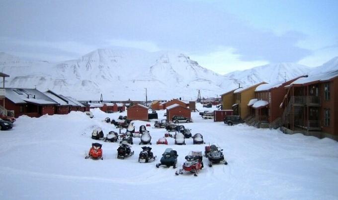 V zimním období, všichni obyvatelé a turisté pohybovat na sněžných skútrech (Longyearbyen, Norsko).